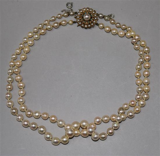 A 1960s double strand cultured pearl necklace with 9ct gold, cultured pearl and turquoise set clasp, 43cm.